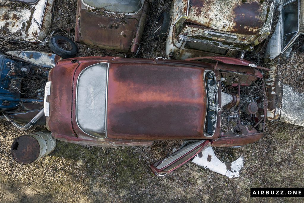 Red, rusty, forgotten car.